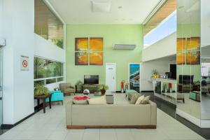 a living room with a couch and a table at Mar de Ponta Negra in Natal