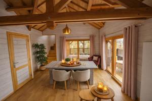 a dining room with a table and chairs in a house at Le château des fées in Illoud