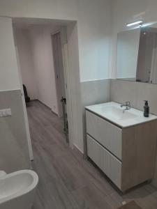 a bathroom with a sink and a toilet and a mirror at Case Quattro Venti in Chiesa Nuova +15 photos
