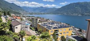 a view of a city and a body of water at Hotel Barca Blu in Orselina