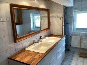 a bathroom with a sink and a mirror at Storchennest im Leinetal in Einbeck +7 photos