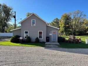 a house with chairs and a gravel driveway at Strip Location Pet Friendly Fire Pit in Geneva