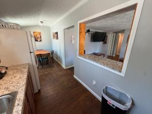 a kitchen with a mirror and a dining room with a table at Strip Location Pet Friendly Fire Pit in Geneva