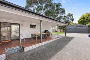 an extension to a house with a wooden deck at Chic coastal living in Anglesea
