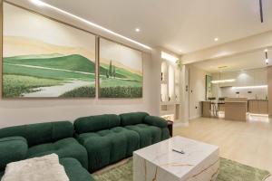 a living room with a green couch and a table at The District Lekki by GCI in Lekki Phase 1