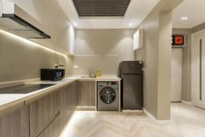a kitchen with a washer and a dishwasher at The District Lekki by GCI in Lekki Phase 1 +106 photos