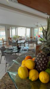 a glass table with a bunch of fruit on it at Beach Hotel Juquehy in Juquei