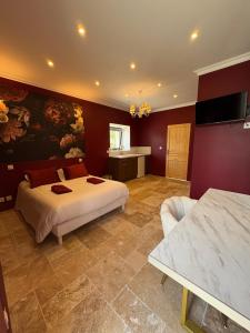 a large bedroom with a bed and a couch at Domaine Des Hêtres in Longraye