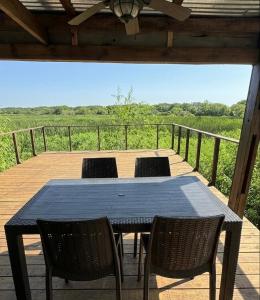 a table and chairs on a deck with a view at Casa Sauce Delta in Tigre