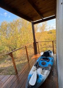a blue kayak sitting on a wooden deck at Casa Sauce Delta in Tigre +3 photos