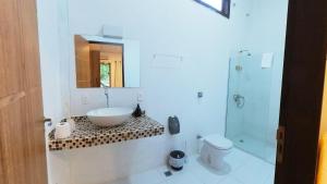 a bathroom with a sink and a toilet and a shower at Refugio MontSerrat in Urubici +72 photos