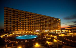 a large building with a large pool in front of it at CHARLOTTE STUDIOS BY BLAXY RESORT Olimp in Olimp