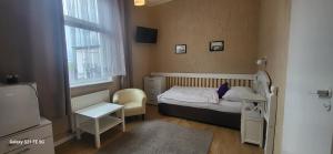 a small bedroom with a small bed and a window at Skarb Morza in Międzyzdroje