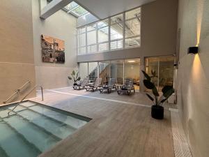 a large room with a swimming pool in a building at Novotel Santiago Vitacura in Santiago