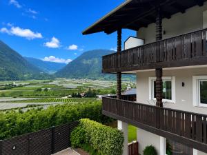 a view from the balcony of a house with mountains in the background at Apartment Torggl Alpenblick in Coldrano