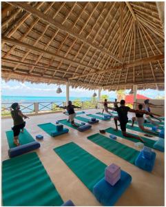 a group of people doing yoga on the beach at Casa Coco by Coco B Isla in Isla Mujeres