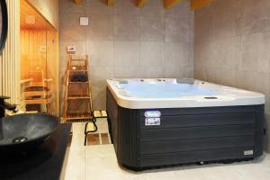 a bath tub in a bathroom with a sink at Wellness Chalupy LETOKRUHY in Jeseník +71 photos