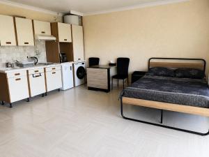 a bedroom with a bed and a small kitchen at Vue Panoramique Vence Balcon & Calme in Vence