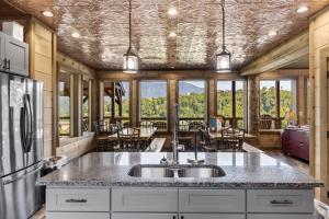 a kitchen with a sink and a table with chairs at Splash N Heavenly Views in Gatlinburg