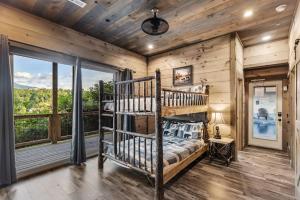 a bedroom with a bunk bed and a window at Splash N Heavenly Views in Gatlinburg +160 photos