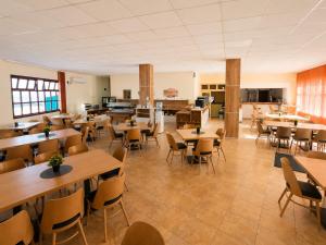 a restaurant with tables and chairs in a room at Palma Beach Hotel in Kranevo
