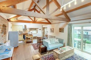 a living room with a couch and a table at 1 Bed in Stoke Abbott oc-35012 in Burstock