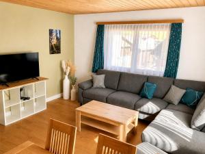 a living room with a couch and a table at Chasa ARLU in Samnaun