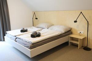a bedroom with a bed with two hats on it at Wellness Chalupy LETOKRUHY in Jeseník