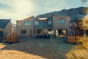 a large house with a mountain in the background at Black Hills Caviahue in Caviahue