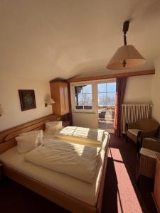 a bedroom with a bed and a large window at Landhaus Lührmann in Ramsau am Dachstein +75 photos
