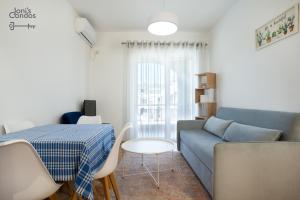 a living room with a couch and a table at Joni's Small Condo in Golem