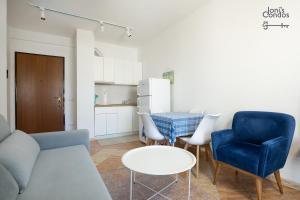 a living room with a couch and chairs and a table at Joni's Small Condo in Golem