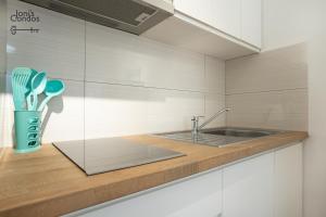 a kitchen with a sink and a counter top at Joni's Small Condo in Golem +19 photos