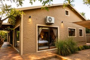 a brick house with a bedroom and a window at Wonderviews Hedgehog in Marloth Park