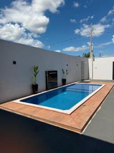 a swimming pool on the roof of a house at Lotus in Gurupi