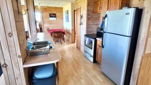 a kitchen with a white refrigerator in a tiny house at Blue Spruces Cottages in Hampton 