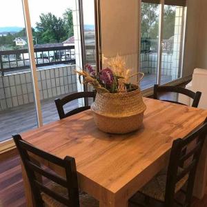 a wooden table with a bowl of flowers on it at Casa Zacarias - Bonitas vistas en La Rioja in Herramélluri
