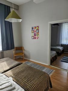 a bedroom with a mirror and a bed and a chair at Hotel Suonenjoki in Suonenjoki