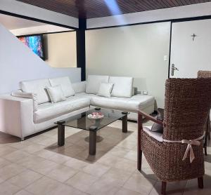a living room with a white couch and a glass table at Apartamento Amoblado Refugio Mérida in Mérida