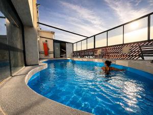 a person in a swimming pool in a building at LRH Viña del Mar and Convention Center - Ex Gala Hotel in Viña del Mar