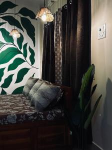 a bedroom with a couch and a curtain and a plant at Oak & olive stays in Tezpur