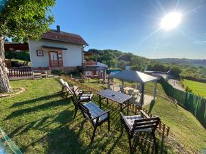 a group of chairs and a picnic table in a yard at Avala Sunset Apartments in Belgrade