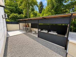 a black building with chairs and tables on it at phranta in Gonio