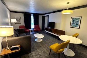 a living room with a couch and tables and chairs at Palette Las Vegas in Las Vegas