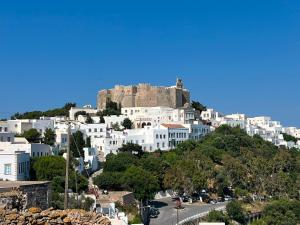 a city with a castle on top of a hill at Manos House in Chora in Patmos
