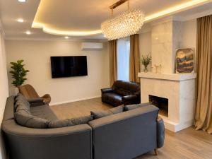 a living room with a couch and a fireplace at phranta in Gonio
