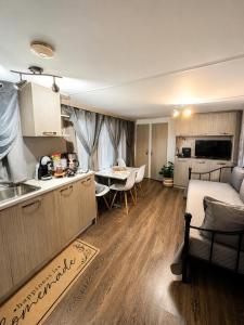 a kitchen and living room with a table and a couch at Glykofilousa Tiny Ηouse in Petra