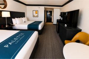 a hotel room with two beds and a flat screen tv at Palette Las Vegas in Las Vegas +34 photos