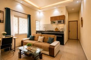 a living room with a couch and a table at Aparthotel Madeleine in Antananarivo