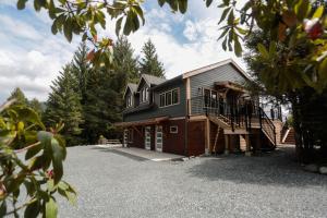 a house with a large driveway in front of it at The Four Cedars in Ucluelet